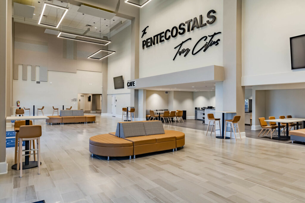 Side view of The Pentecostals Twin Cities metal wall logo and ceiling lights designed by TBA Studio